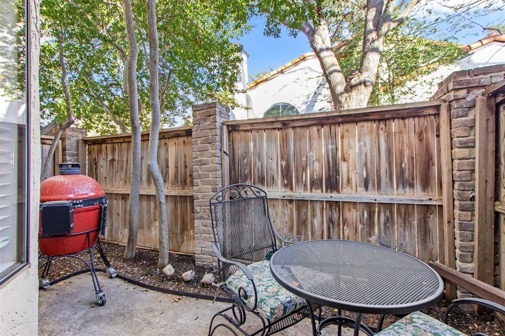18040 Midway Road, Unit 103 Dallas, TX 75287 - Photo 22 of 38 a backyard of a house with table and chairs