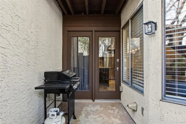 a backyard of a house with table and chairs