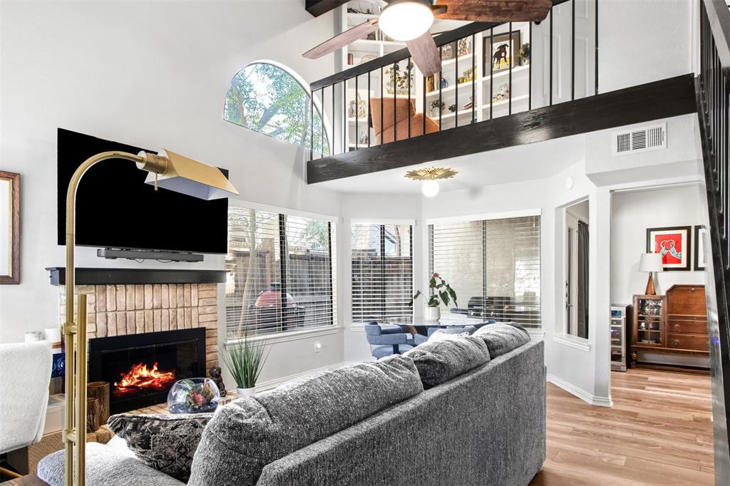 18040 Midway Road, Unit 103 Dallas, TX 75287 - Photo 35 of 38 a living room with furniture fireplace and flat screen tv