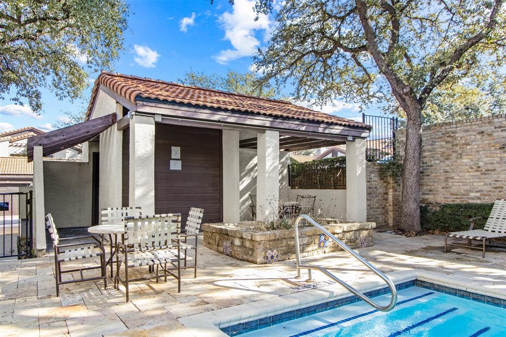 18040 Midway Road, Unit 103 Dallas, TX 75287 - Photo 30 of 38 a view of a patio with table and chairs and potted plants