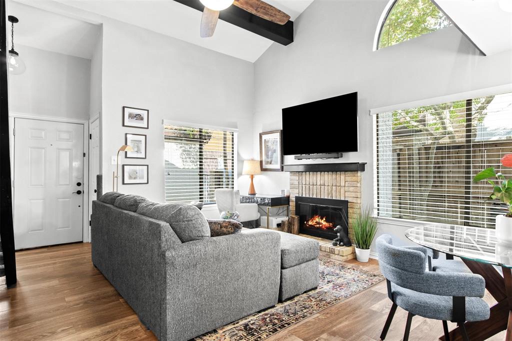 18040 Midway Road, Unit 103 Dallas, TX 75287 - Photo 36 of 38 a living room with furniture flat screen tv and a fireplace