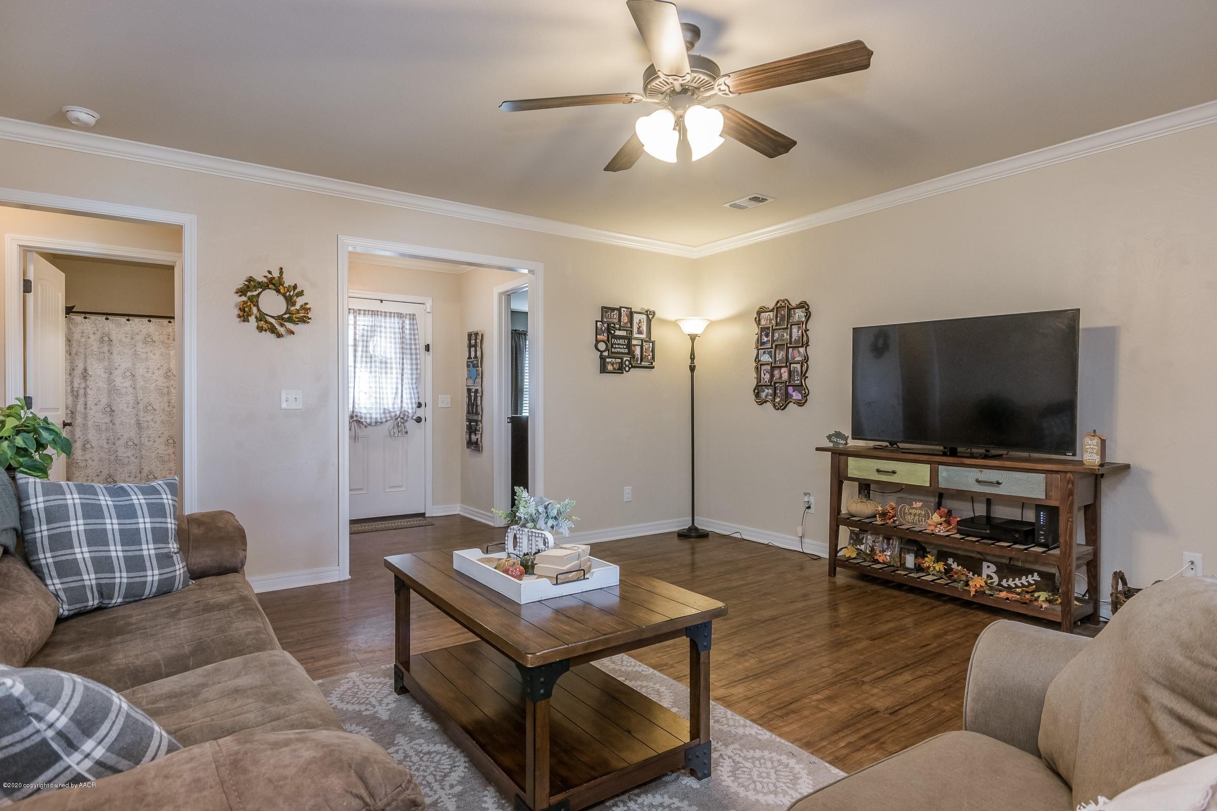 2808 Simkins Lane Amarillo, TX 79118 - Photo 3 of 20 a living room with furniture and a flat screen tv