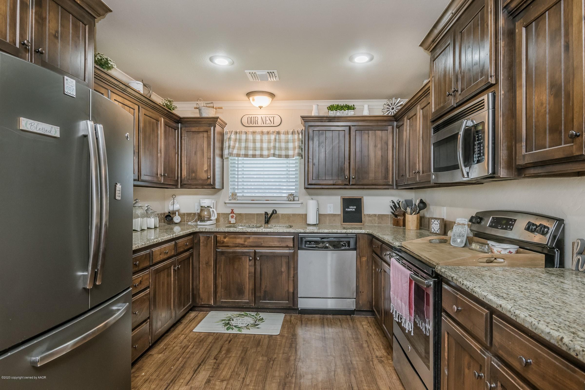 2808 Simkins Lane Amarillo, TX 79118 - Photo 4 of 20 a kitchen with stainless steel appliances granite countertop a sink stove and refrigerator