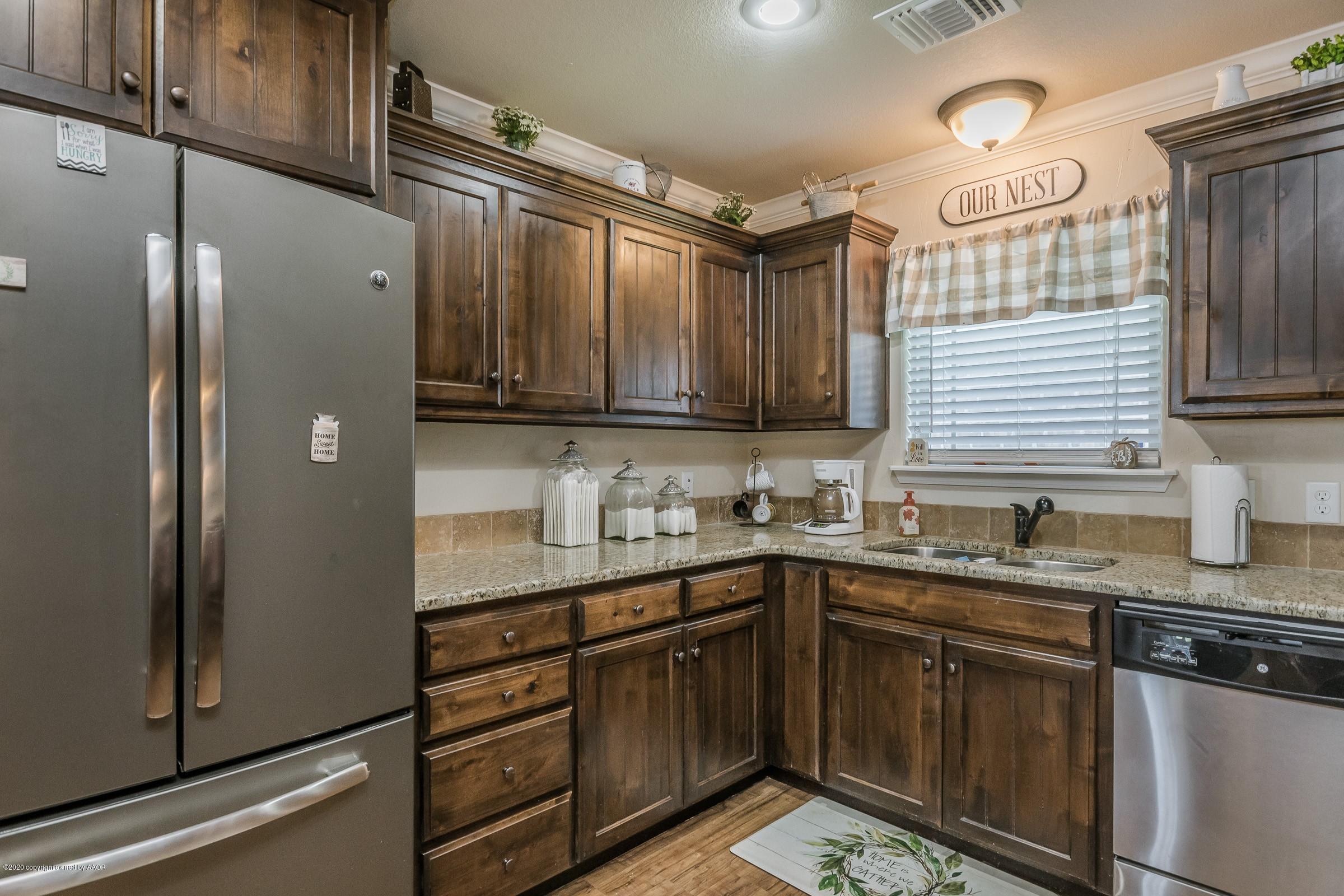 2808 Simkins Lane Amarillo, TX 79118 - Photo 5 of 20 a kitchen with stainless steel appliances granite countertop a sink stove and refrigerator