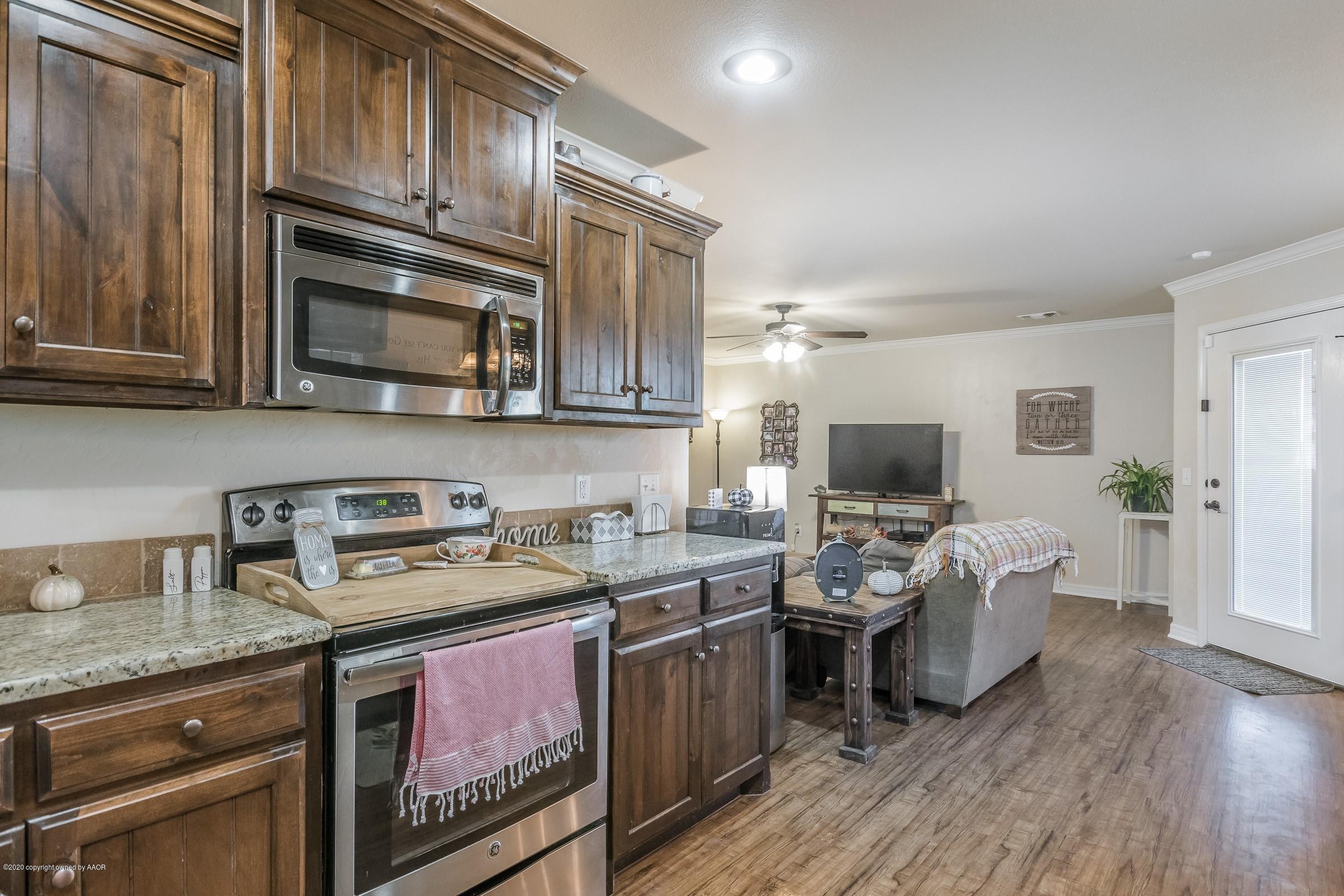 2808 Simkins Lane Amarillo, TX 79118 - Photo 6 of 20 a kitchen with a stove microwave and sink