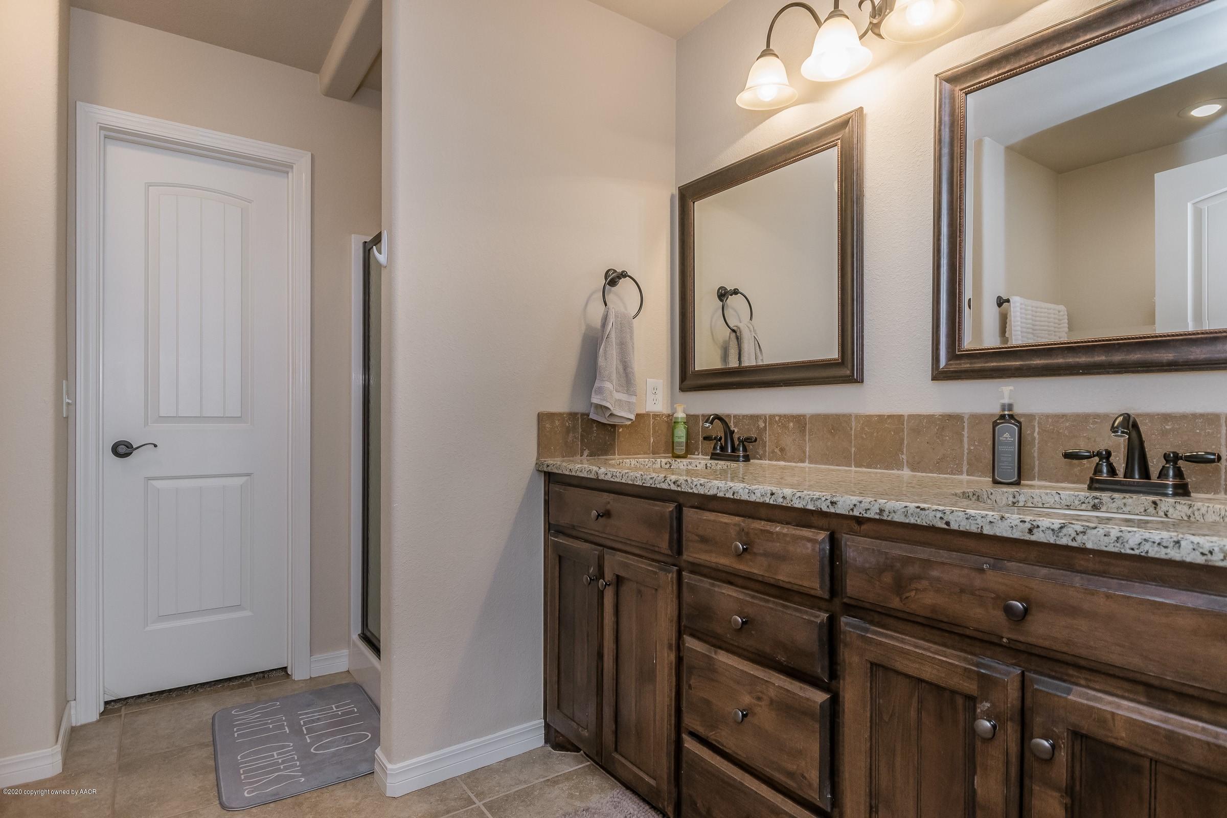 2808 Simkins Lane Amarillo, TX 79118 - Photo 9 of 20 a bathroom with a granite countertop sink vanity and mirror