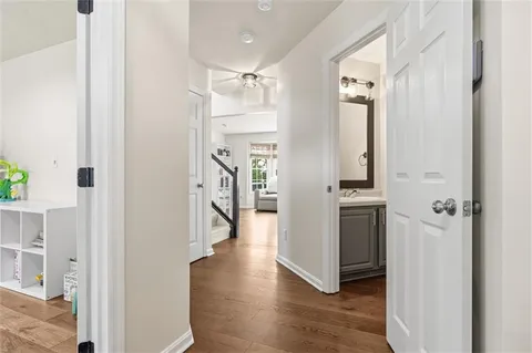 a view of a hallway with wooden floor and staircase