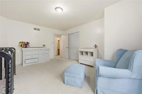 a living room with furniture cabinets and a window