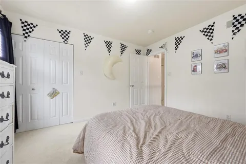 a bedroom with a bed and a white door