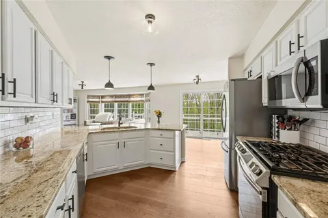 a kitchen with stainless steel appliances granite countertop a stove and a sink