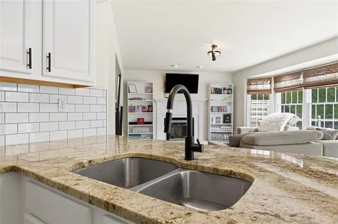 a kitchen with a sink and a wooden floor