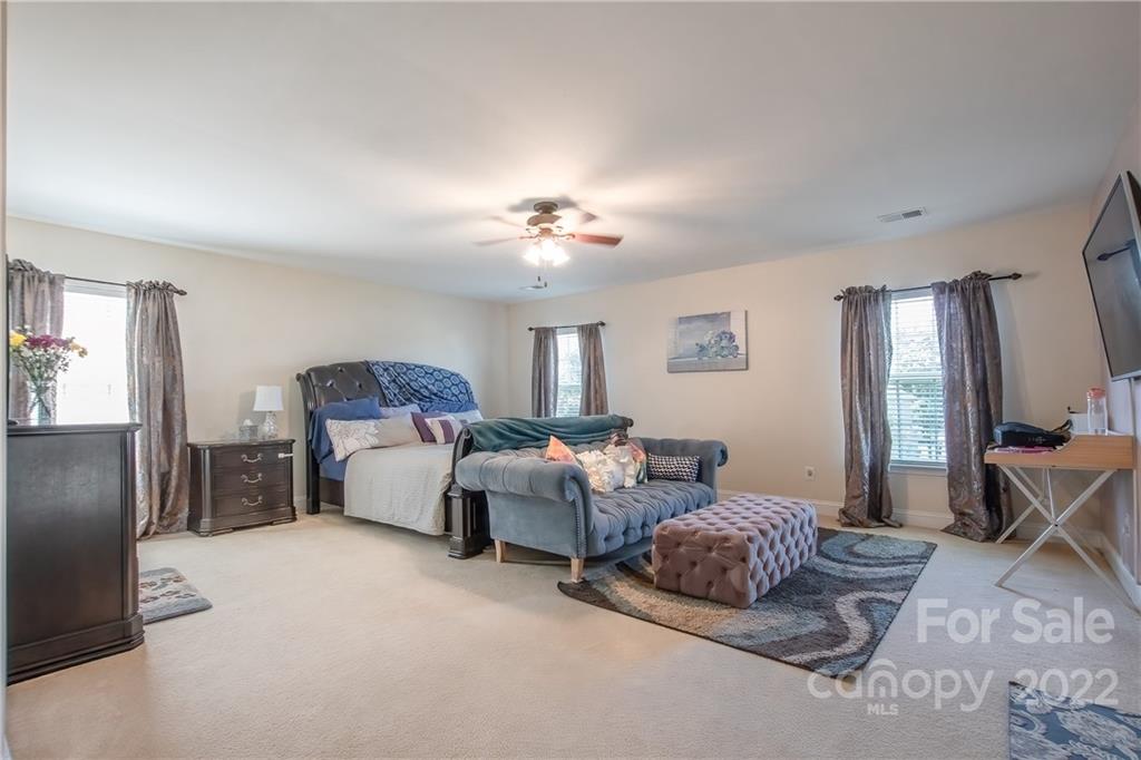 6809 Evanton Loch Road Charlotte, NC 28278 - Photo 12 of 30 a living room with furniture and a chandelier