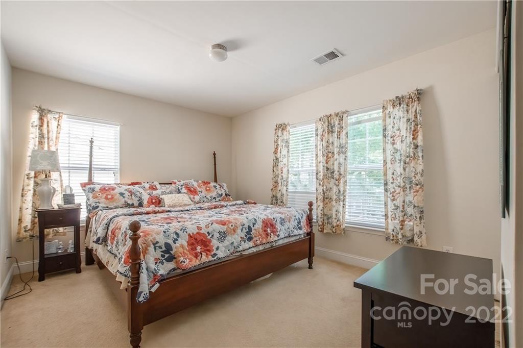 6809 Evanton Loch Road Charlotte, NC 28278 - Photo 15 of 30 a bed sitting in a spacious bedroom next to a window