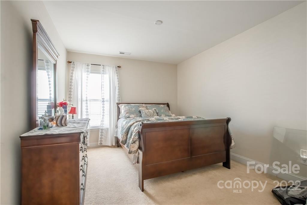 6809 Evanton Loch Road Charlotte, NC 28278 - Photo 16 of 30 a bed sitting in a bedroom next to a window