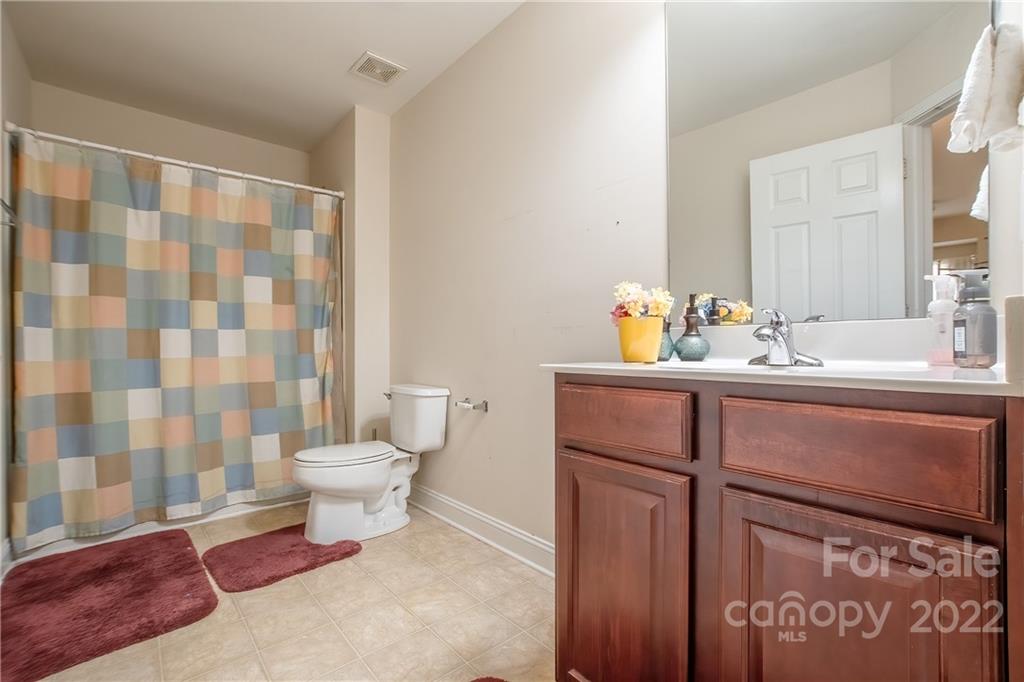 6809 Evanton Loch Road Charlotte, NC 28278 - Photo 18 of 30 a bathroom with a sink toilet and shower