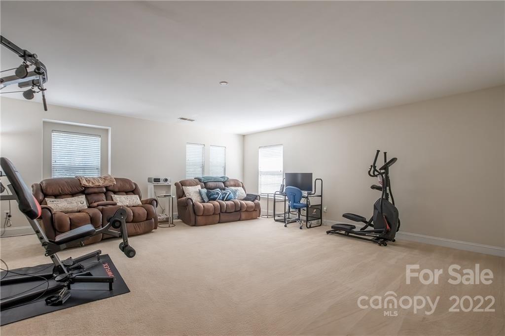 6809 Evanton Loch Road Charlotte, NC 28278 - Photo 20 of 30 a room with gym equipment and a window