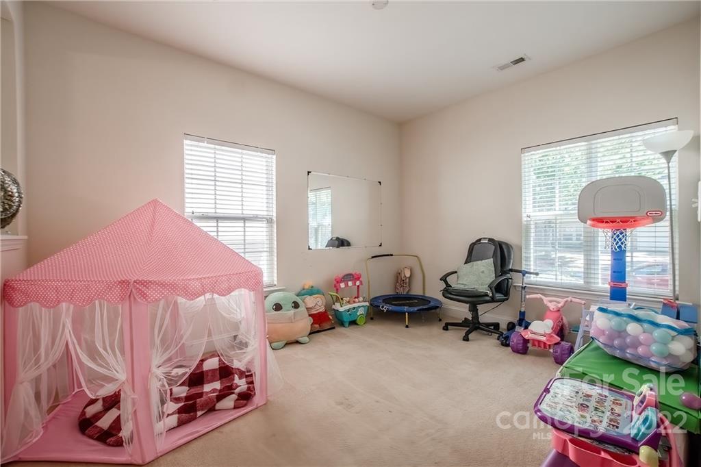 6809 Evanton Loch Road Charlotte, NC 28278 - Photo 21 of 30 a bedroom with furniture and a bed