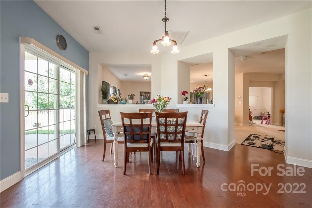 6809 Evanton Loch Road Charlotte, NC 28278 - Photo 5 of 30 a view of a dining room with furniture window and wooden floor