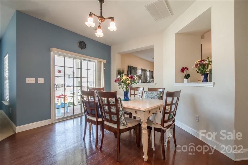 6809 Evanton Loch Road Charlotte, NC 28278 - Photo 6 of 30 a view of a dining room with furniture a chandelier and wooden floor