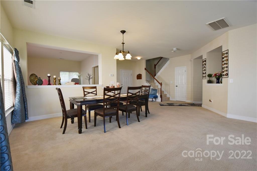 6809 Evanton Loch Road Charlotte, NC 28278 - Photo 10 of 30 a dining room with a table and chairs
