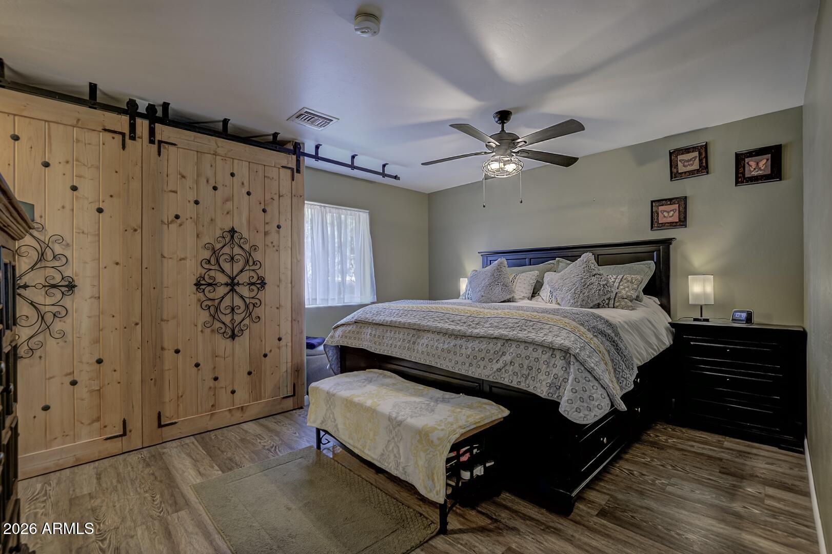 3762 Watertank Road Pine, AZ 85544 - Photo 14 of 38 a bedroom with a bed and a ceiling fan