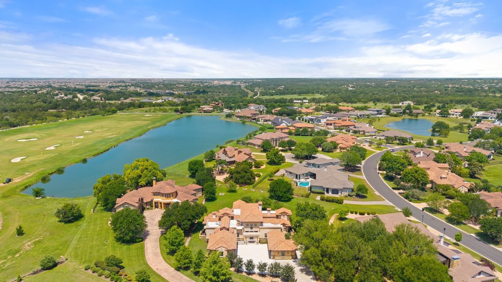 102 Long Point Cove Georgetown, TX 78628 - Photo 2 of 36 an aerial view of residential houses with outdoor space and lake view in back