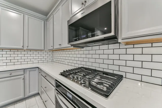 a kitchen with a stove a microwave and sink