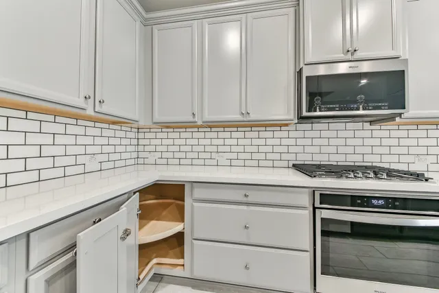 a kitchen with a sink stove and cabinets