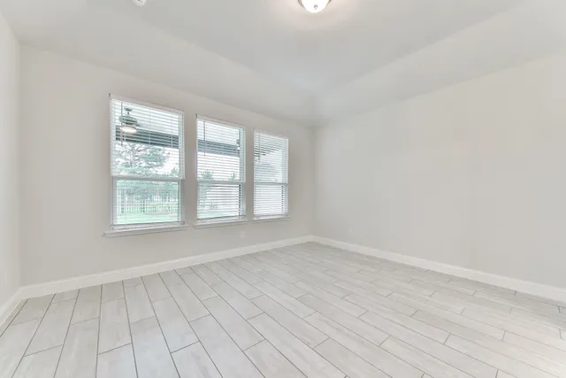 wooden floor in an empty room with a window