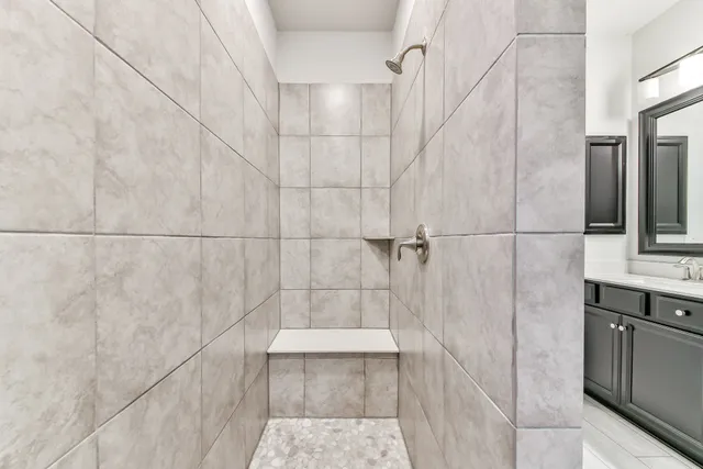 a bathroom with a shower and a sink