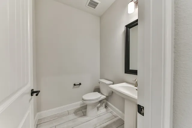 a white toilet sitting next to a bathroom sink