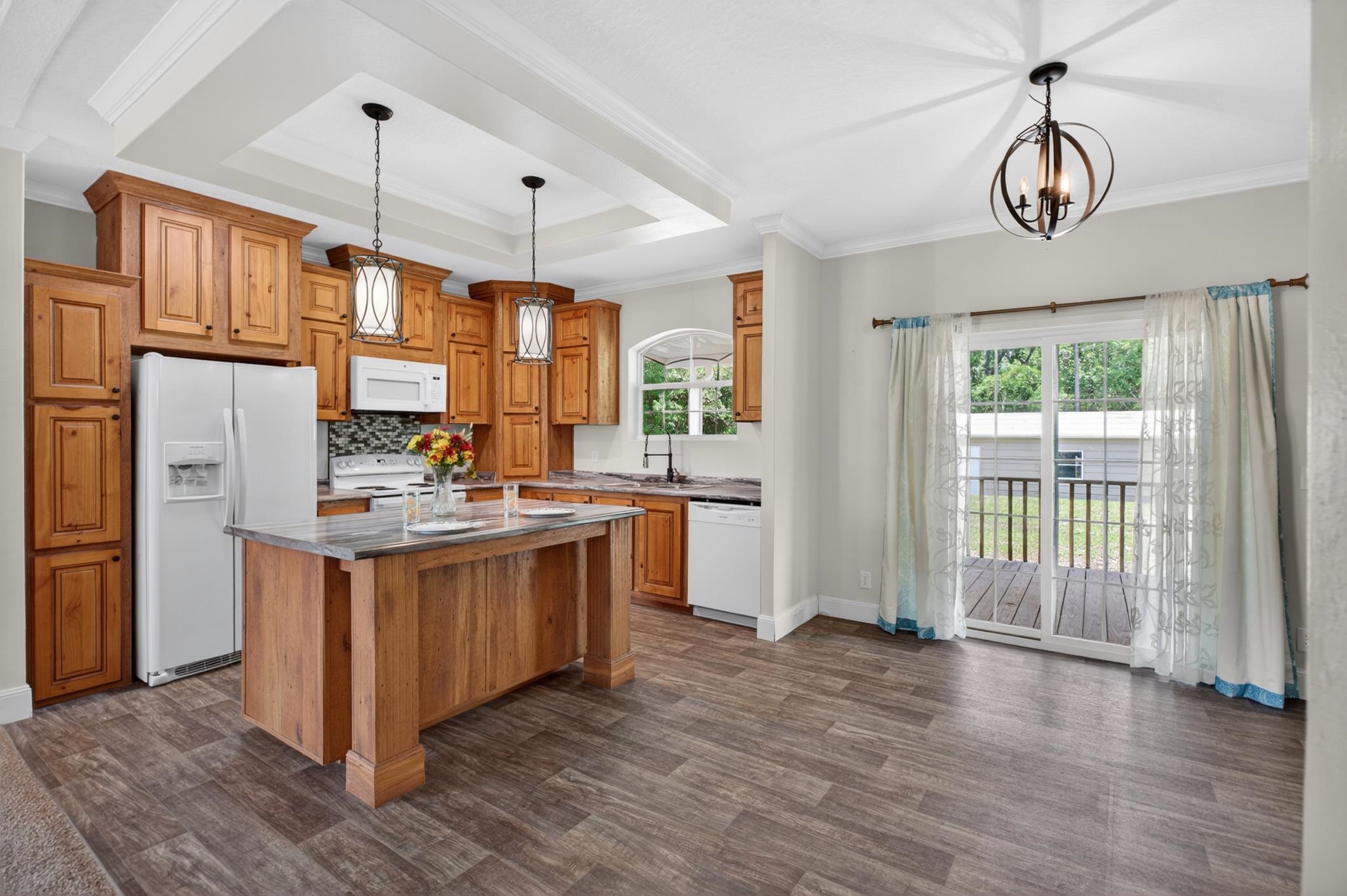 101 Trout Trail Crescent City, FL 32112 - Photo 11 of 45 a kitchen with stainless steel appliances granite countertop a stove a sink dishwasher a refrigerator and a dining table