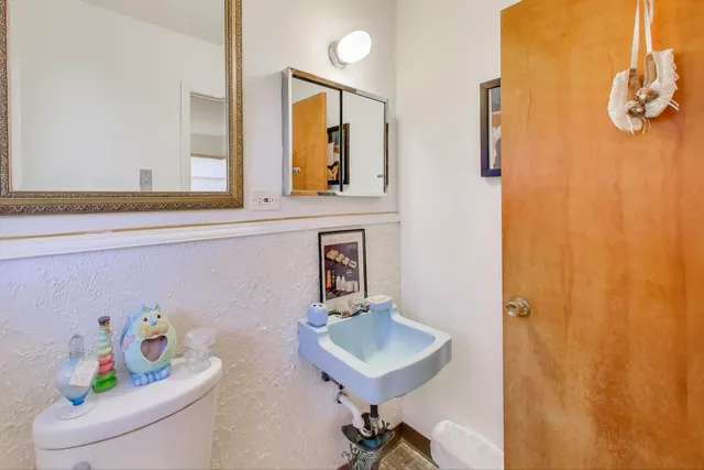 a bathroom with a sink a mirror and a window