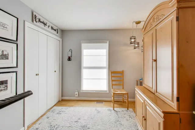 a view of an empty room with window and stairs