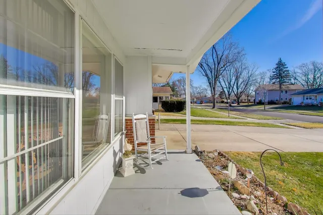 a view of a swimming pool with a patio and a yard