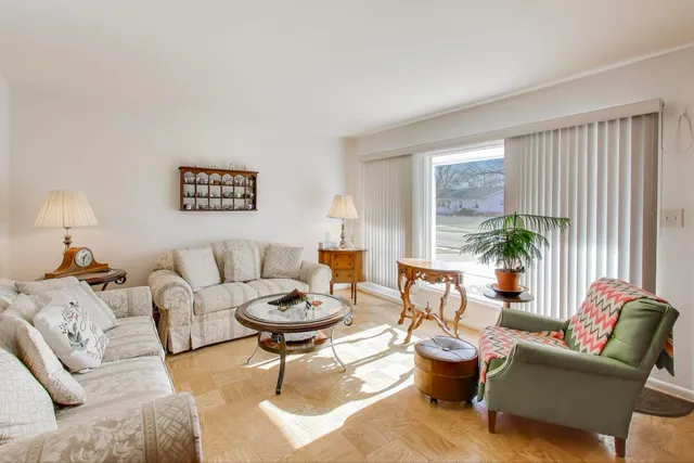 a living room with furniture a rug and a window