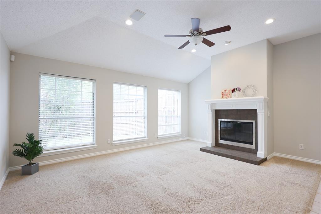 8112 Dock Street Frisco, TX 75035 - Photo 9 of 34 a view of livingroom with window fireplace and ceiling fan