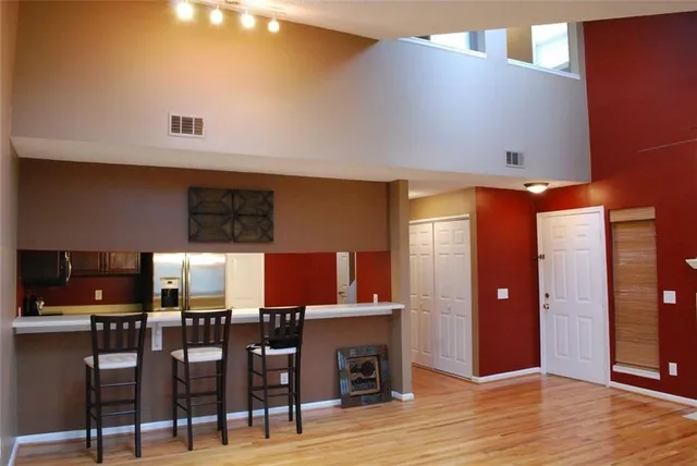 a view of a kitchen with cabinets and wooden floor