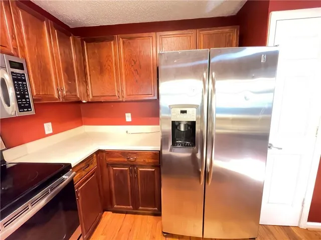 a kitchen with kitchen island a counter top space cabinets and stainless steel appliances