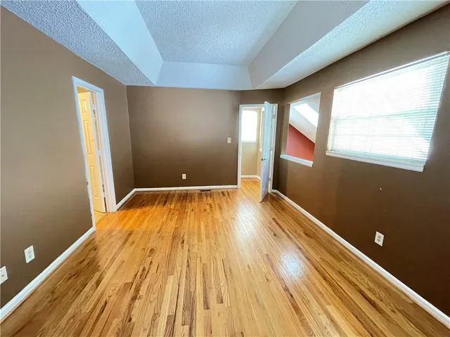 a view of a room with wooden floor and entrance