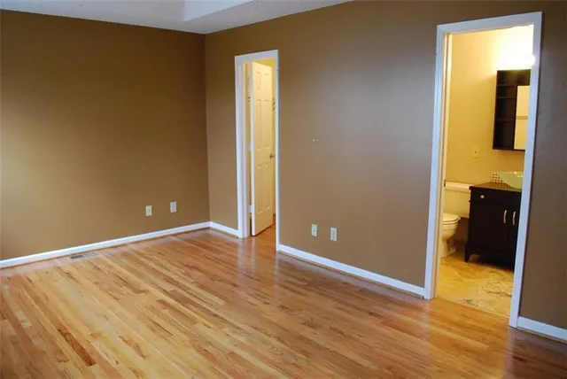 a view of a room with wooden floor