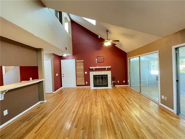 a view of livingroom with kitchen and fireplace
