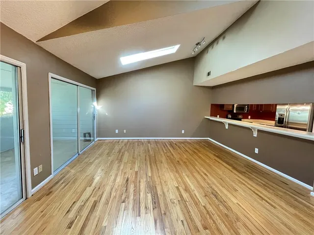 a view of a room with wooden floor
