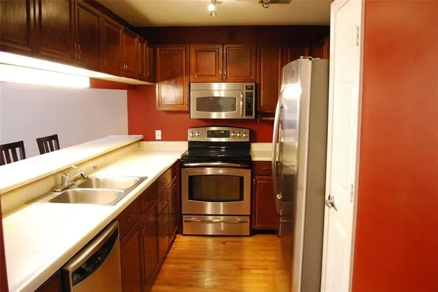 a kitchen with a stove and a refrigerator