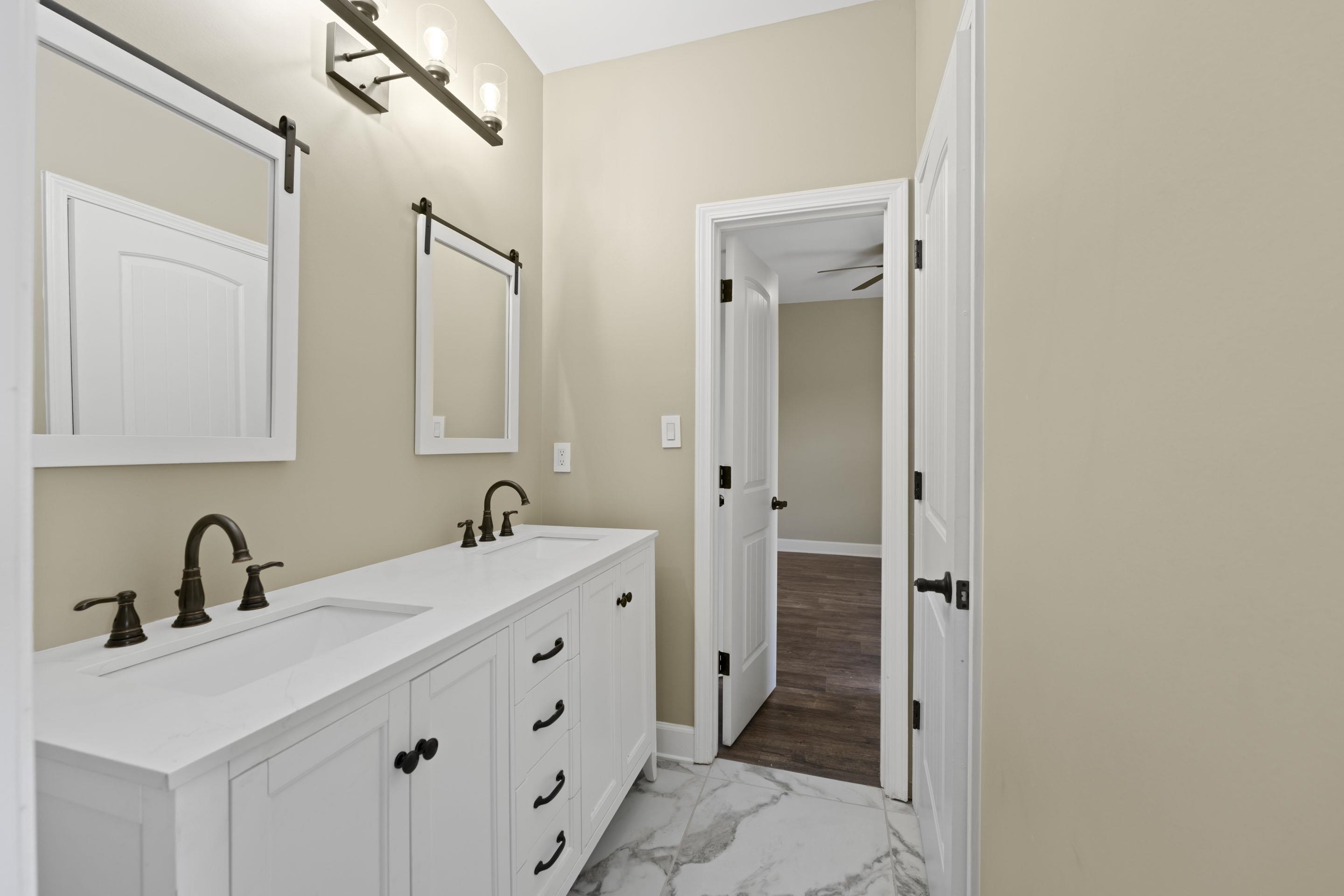 2295 Tomlin Road Somerville, TN 38068 - Photo 25 of 38 Full bath with marble look tile flooring and double vanity