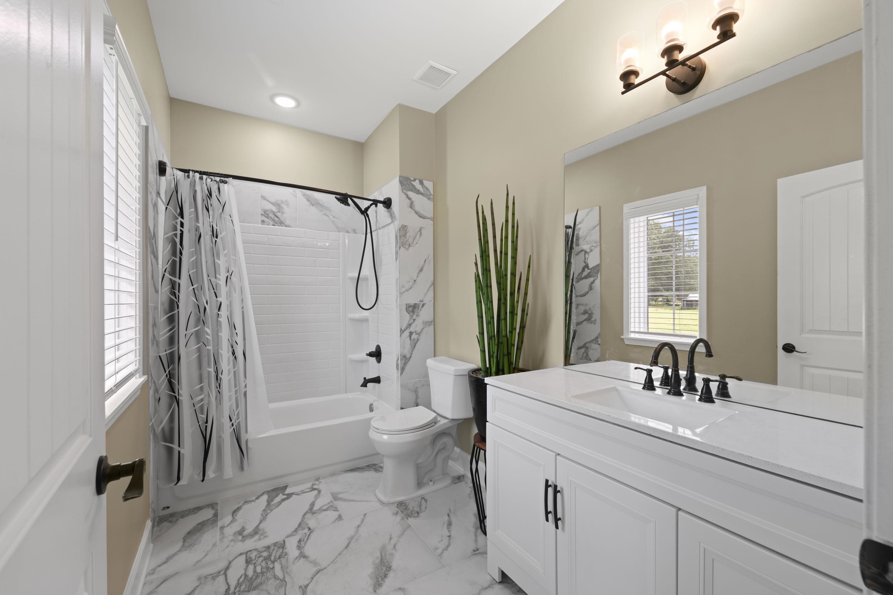 2295 Tomlin Road Somerville, TN 38068 - Photo 28 of 38 Full bathroom featuring shower / bathtub combination with curtain, vanity, and marble finish floors