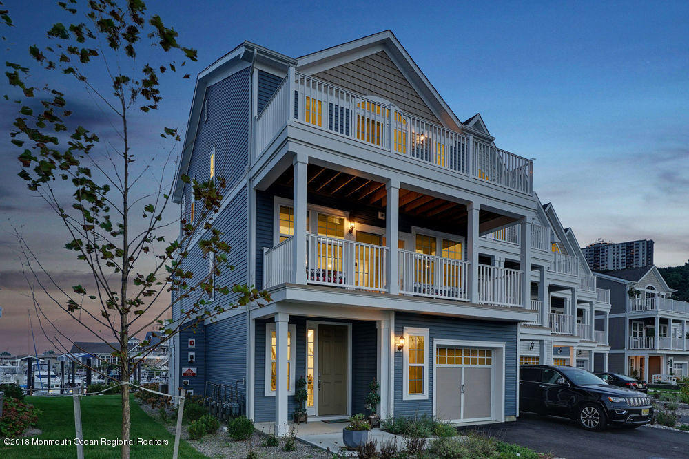 11 Lighthouse Point Road, Unit 601 Highlands, NJ 07732 - Photo 2 of 79 a front view of a residential apartment building with a yard