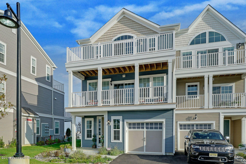 11 Lighthouse Point Road, Unit 601 Highlands, NJ 07732 - Photo 3 of 79 a front view of a residential apartment building with a yard