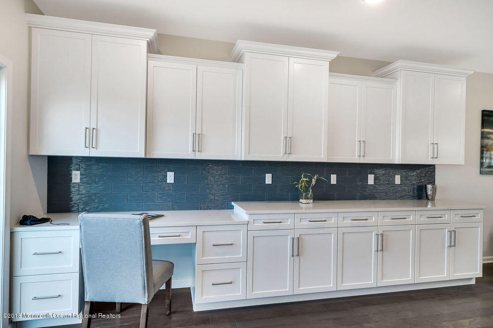 11 Lighthouse Point Road, Unit 601 Highlands, NJ 07732 - Photo 25 of 79 a kitchen with white cabinets and white appliances