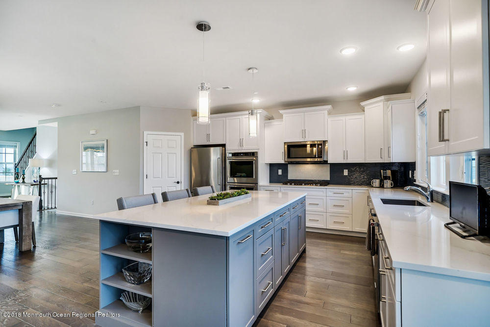 11 Lighthouse Point Road, Unit 601 Highlands, NJ 07732 - Photo 26 of 79 a large kitchen with kitchen island a sink a counter space and stainless steel appliances
